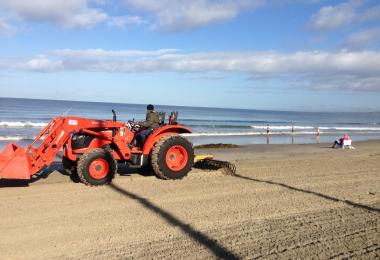 Beach grooming machinery, with rake behind and scoop in front. Credit: Monique Myers Beach grooming machinery, with rake behind and scoop in front. Credit: Monique Myers